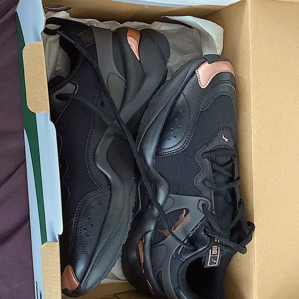 Puma shoes black with rose gold trim. Never been worn.